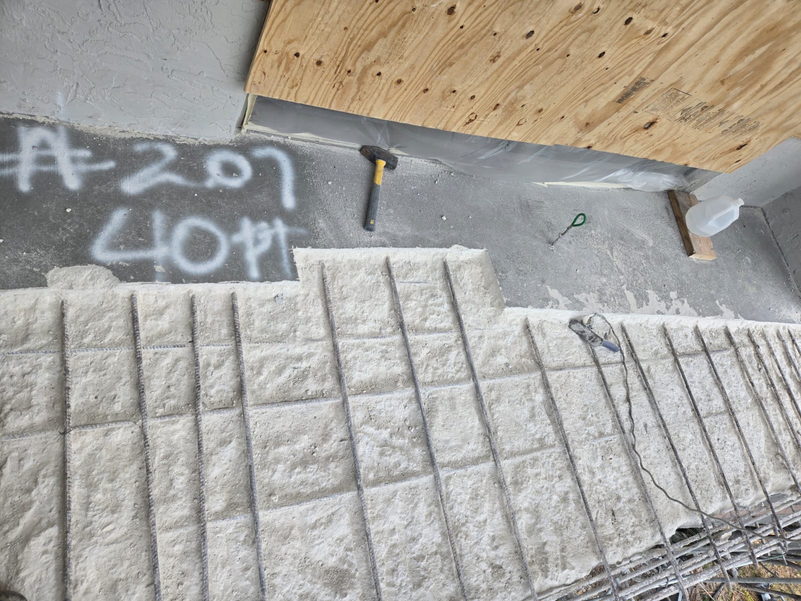 Authentic client overhead concrete balcony spall cutout and rebar repair