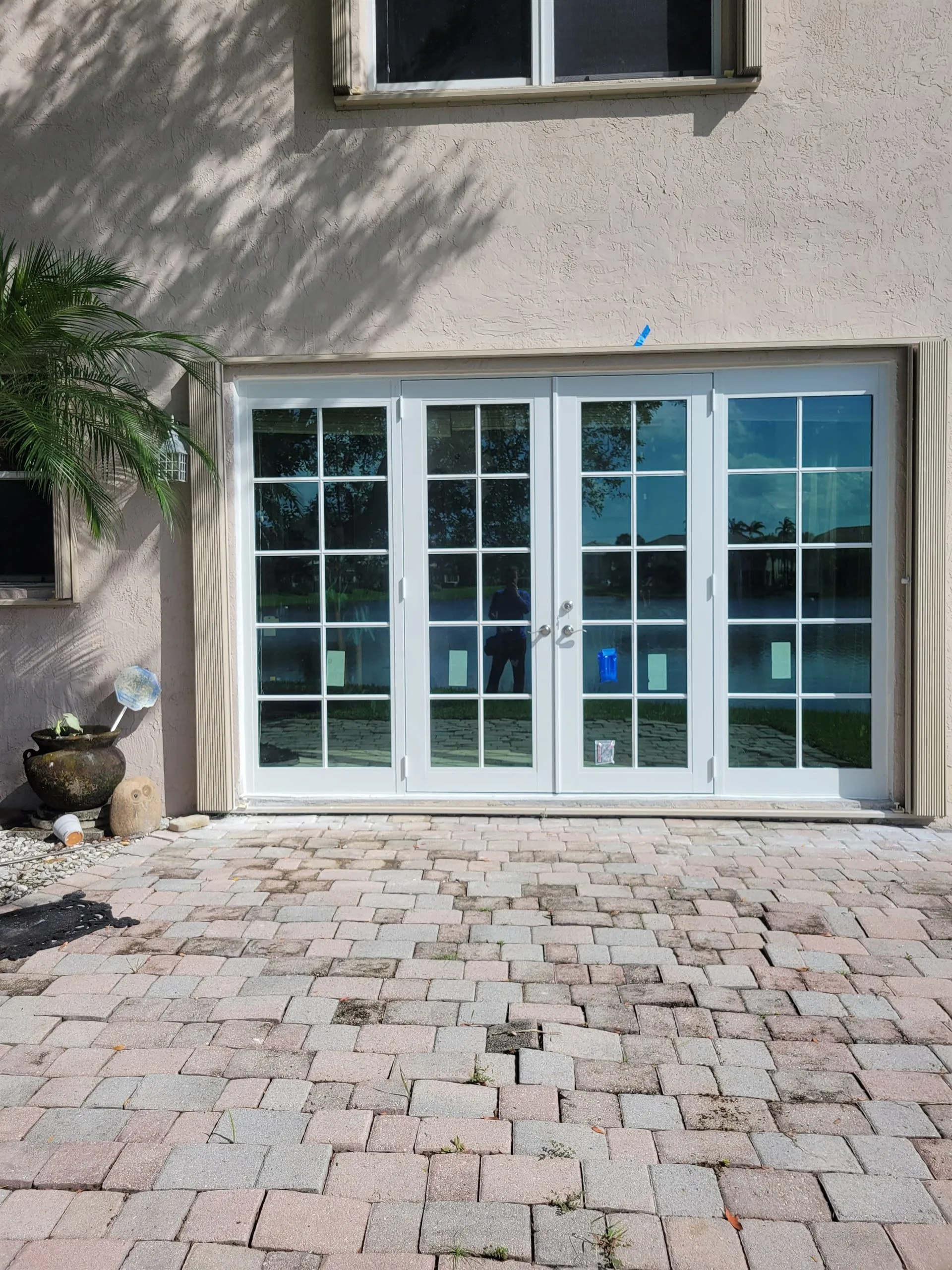 Completed Category 5 impact French patio doors on waterfront Fort Lauderdale residence by Planet Construction